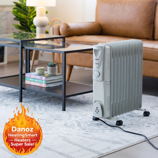 Portable electric heater in a living room setting with a couch and coffee table.