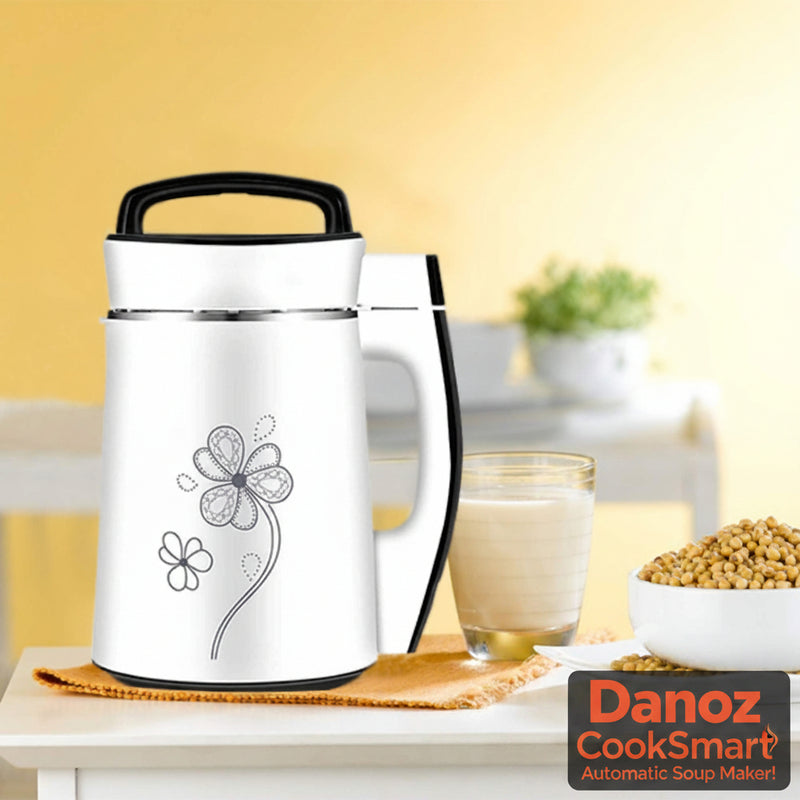 An electric soup and soy bean milk machine displayed alongside a glass of milk and a bowl of soybeans, emphasizing its function as an almond, nut, and soy milk blender.
