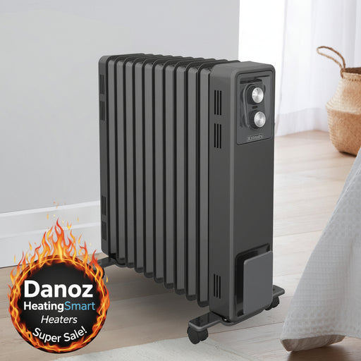 Black oil-filled radiator on a wooden floor with a light-colored wall and basket in the background.