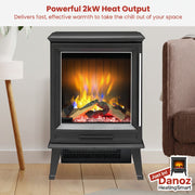 Black electric stove with flames inside, placed in a room with a lamp and chair.