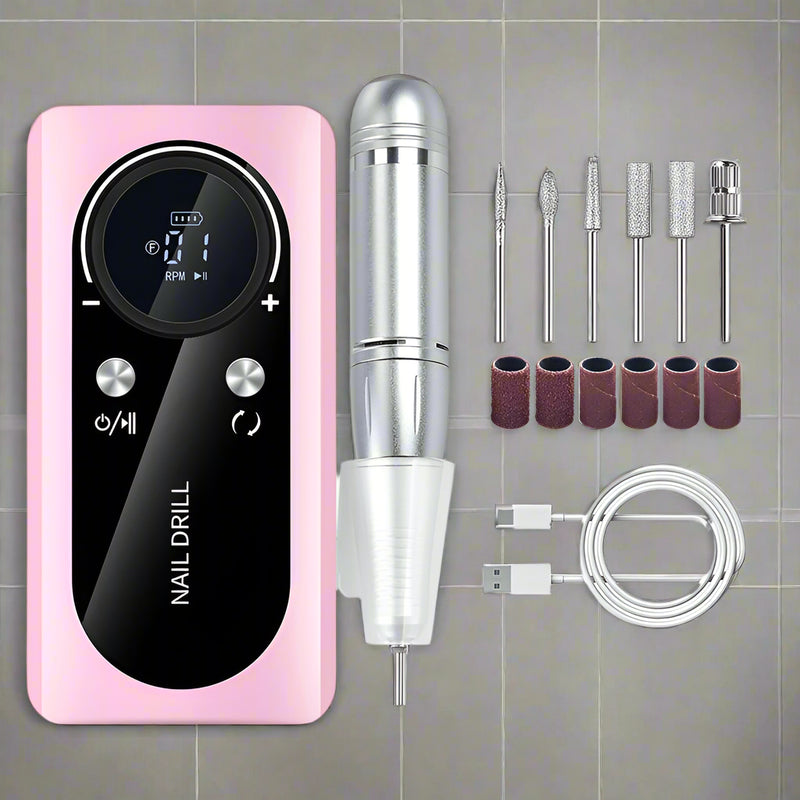 Pink and silver nail drill with attachments on a white background