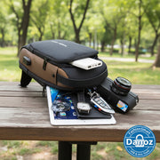 Black and brown backpack with various items on a white background