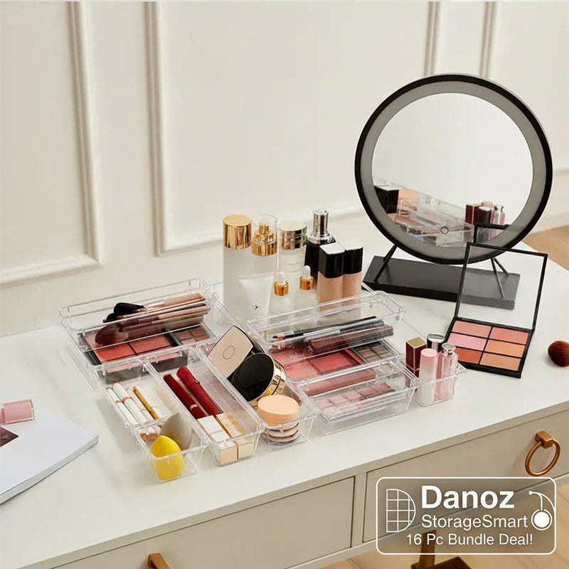 Makeup products on a vanity table with a round mirror