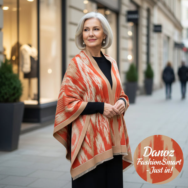 Orange and beige patterned poncho on a white background