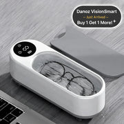 Eyeglasses in a white cleaning device on a wooden surface