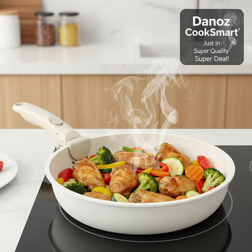 White frying pan with cooked chicken wings on a stove, suitable for all stoves.