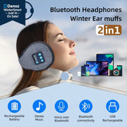 A woman wearing gray wireless headphones that cover the ears and have a control button on the side. The image also shows icons indicating features such as rechargeable battery, stereo music, voice over Bluetooth, Bluetooth connectivity, and USB rechargeable.