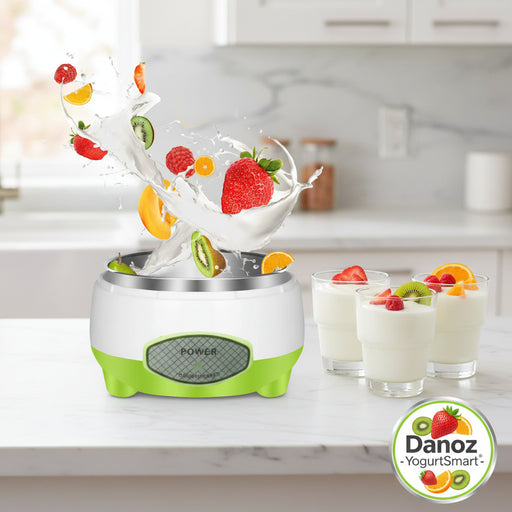 Green and white yogurt maker with fruits and milk splashes on a white background