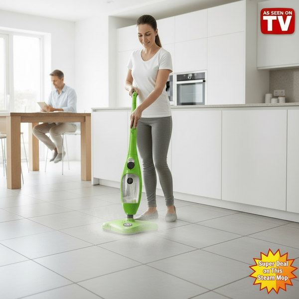 Woman using a green steam mop in a living room with a man sitting on a couch.