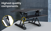 Danoz Direct - Fortia Corner Desk Riser 110cm Wide Adjustable Sit to Stand for Dual Monitor, Keyboard, Laptop, Black - danozdirect