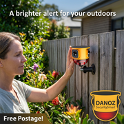 Danoz SecuritySmart yellow solar alarm installed on a garden fence with homeowner and Free Postage