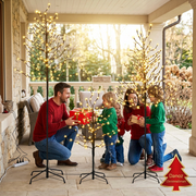 Family exchanging gifts on a covered patio beside the LED trees