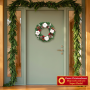 Compact Christmas wreath on a full sage doorway showing realistic product scale