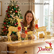 Woman arranging three gold light-up Christmas deer on a console with Free Postage