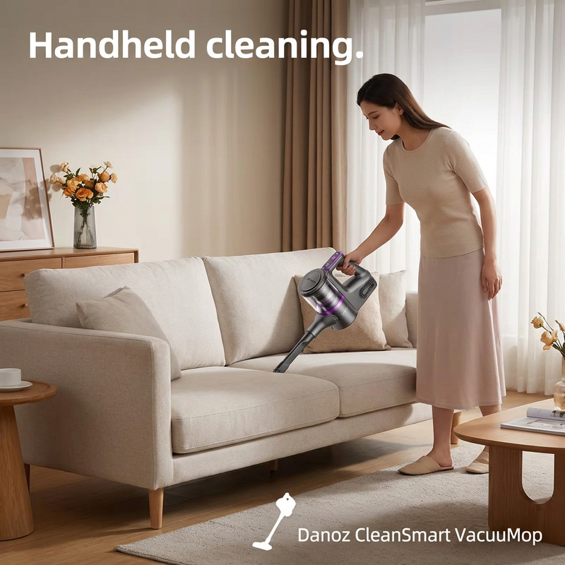 Woman using Danoz CleanSmart handheld vacuum to clean a sofa seam
