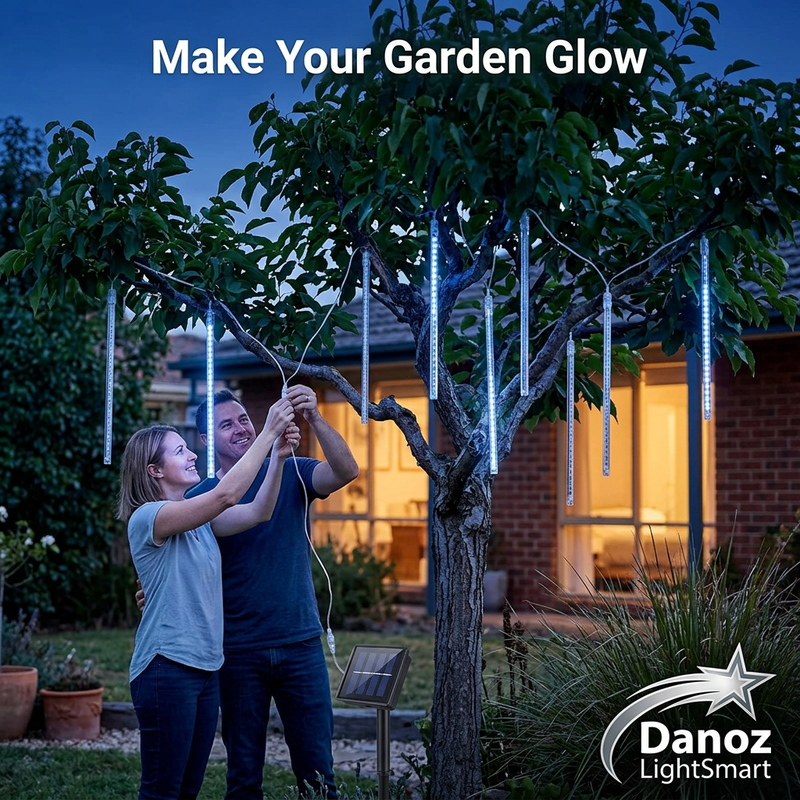 Couple hanging blue meteor shower lights on a garden tree