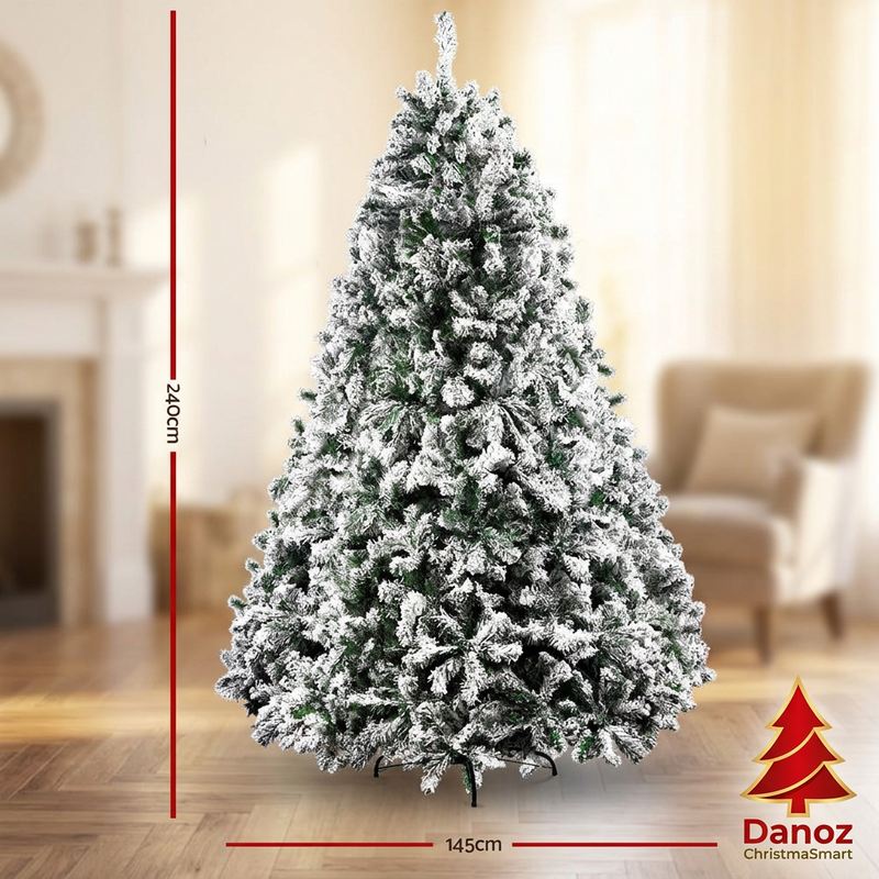 Snow-flocked tree dimensions 240cm high and 145cm wide