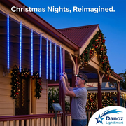 Man installing blue meteor lights on a festive verandah