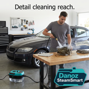 Man detail cleaning a removable metal automotive part on a workbench