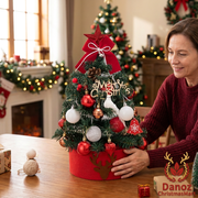 Woman positioning the red and white decorated tree on a dining table