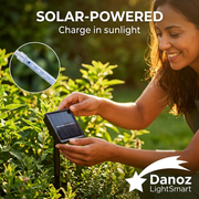 Woman positioning solar panel toward sunlight with LED tube detail