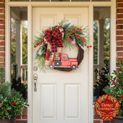 Red pickup truck wreath on cream front door in festive sunlit porch
