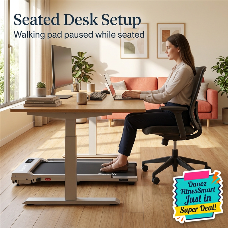 Side-view seated desk setup with treadmill forward under desk and chair wheels on wooden floor behind it; walking pad paused
