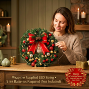 Woman wrapping supplied LED light string around the Christmas wreath, three AA batteries not included