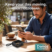Man using a Black 100,000mAh PowerSmart power bank to charge a phone