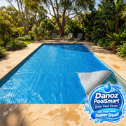 Solar cover on a backyard swimming pool with Danoz PoolSmart blue water-splash badge