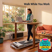 Woman walking on compact silver Everfit walking pad positioned beneath standing desk with bottom-right FitnesSmart badge