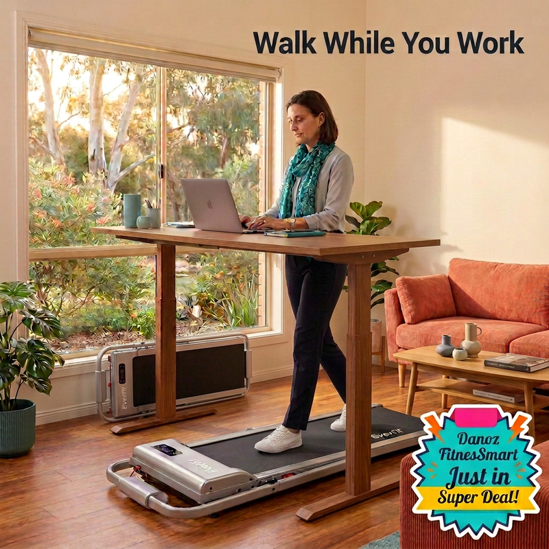 Woman walking on compact silver Everfit walking pad positioned beneath standing desk with bottom-right FitnesSmart badge