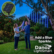 Couple hanging blue meteor lights in an Australian garden