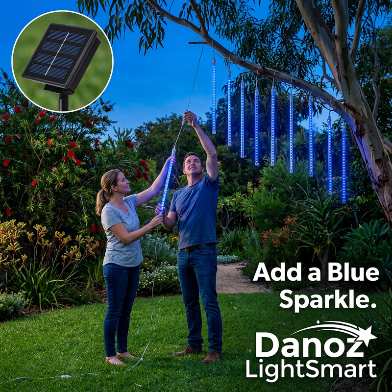 Couple hanging blue meteor lights in an Australian garden