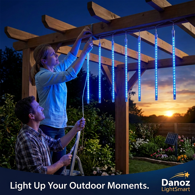 Couple arranging meteor light cable on a garden pergola