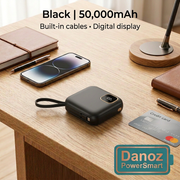 Compact Black 50,000mAh PowerSmart power bank beside a smartphone and card