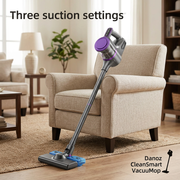 Danoz CleanSmart cordless vacuum with three suction settings beside a living room armchair
