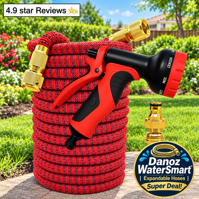 Red garden hose with black and red nozzle and gold connectors on grass
