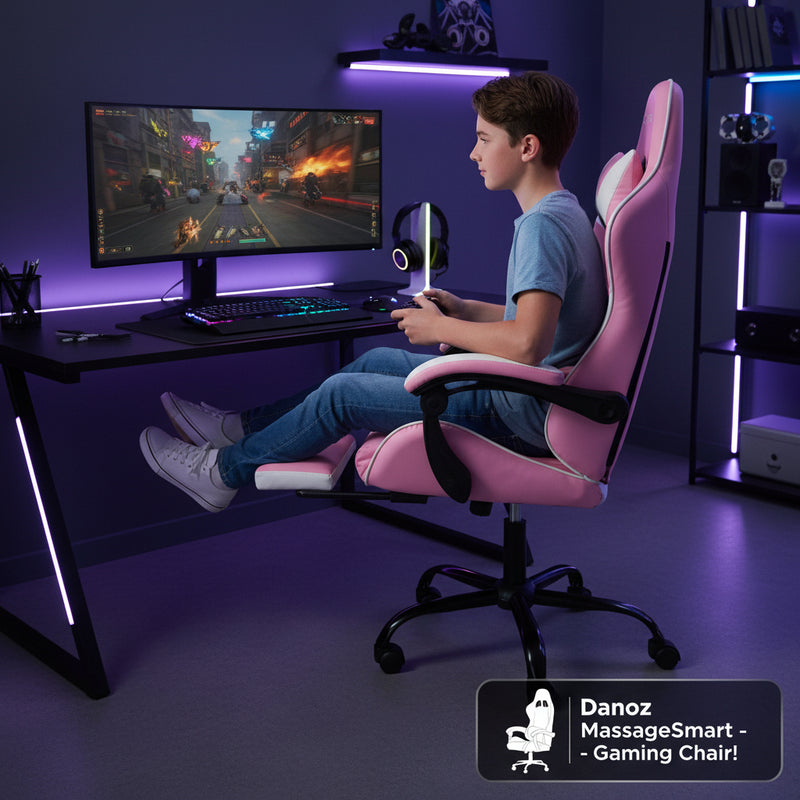 An ergonomic pink and white gaming office chair with a footrest, armrests, and a headrest, set on a sturdy metal base with five dual-wheel castors.