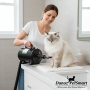 A black i.Pet Pet Hair Dryer with assorted nozzles and a flexible hose laid out on the floor.