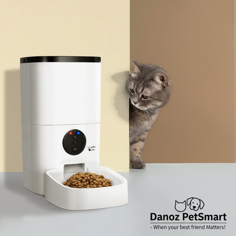 A white i.Pet automatic pet feeder with a cat looking around the corner, indicating the feeder is designed for pet use.