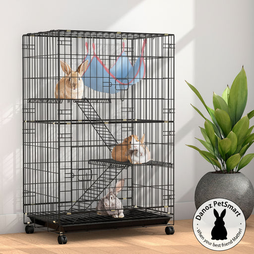 A three-level indoor pet cage with a black powder-coated wrought iron frame, featuring two rabbits on the top two levels, a guinea pig on the top level, and a ferret on the bottom level. The cage has castor wheels for mobility and is placed in a room with natural lighting.